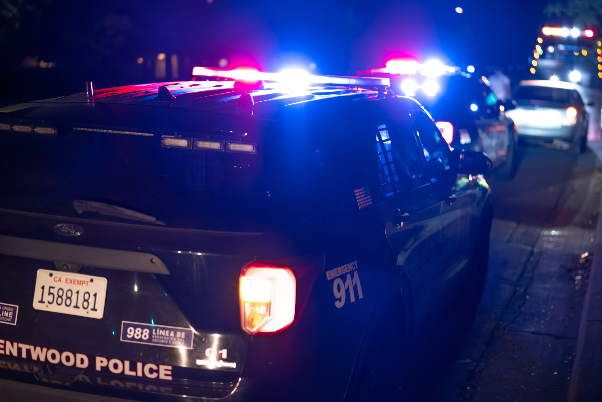 Patrol vehicles with red and blue lights at night